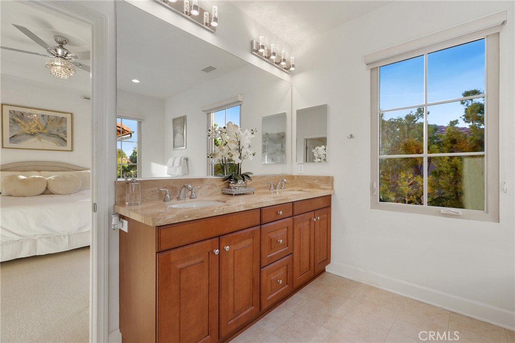 72 Brindisi Irvine, CA 92618 - Photo 24 of 48 a bathroom with a granite countertop sink a mirror and a