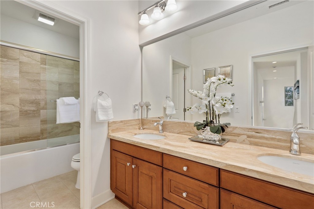 72 Brindisi Irvine, CA 92618 - Photo 29 of 48 a bathroom with a double vanity sink and a mirror