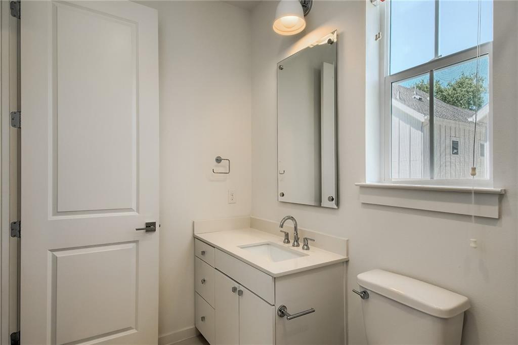 2624 Metcalfe Road, Unit 7 Austin, TX 78741 - Photo 26 of 31 Bathroom featuring a white vanity with an integrated sink, polished chrome faucet, and coordinating hardware