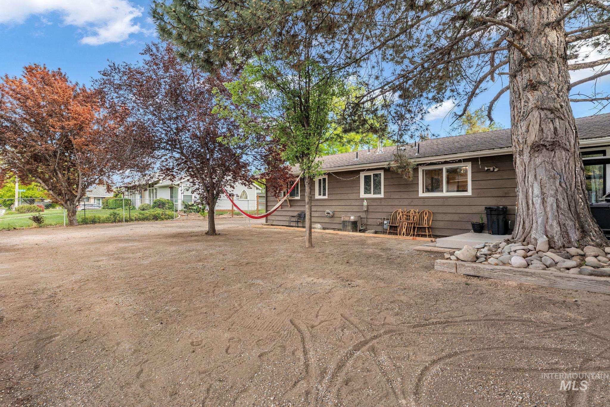 820 Meadows Drive Twin Falls, ID 83301 - Photo 34 of 38 Spacious backyard featuring an exterior storage shed, mature trees, and a privacy fence