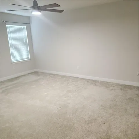 a living room with furniture and large windows