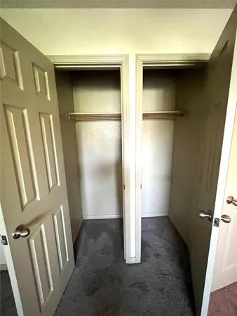 a view of an empty room and a window