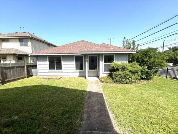 a view of a house with a backyard and a patio