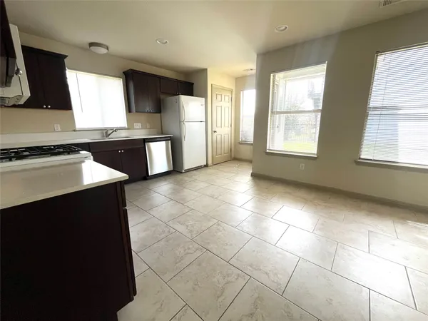 a kitchen with stainless steel appliances a sink a stove a microwave and cabinets