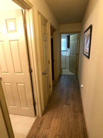 an empty room with fan and windows