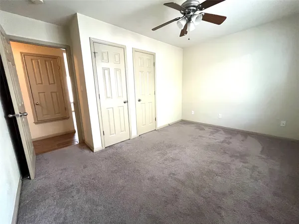a view of room with a ceiling fan and window