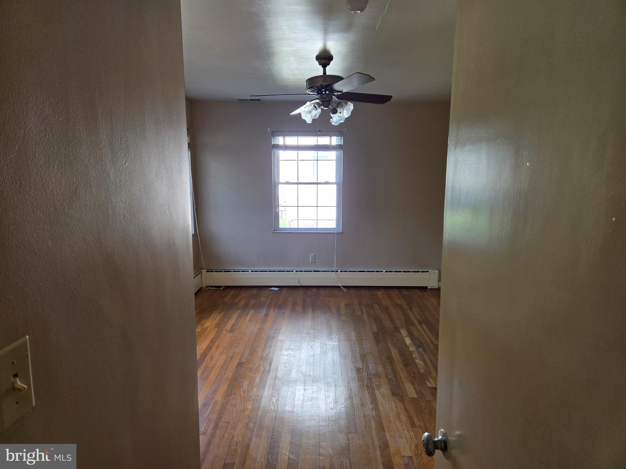 505 East Loockerman Street Dover, DE 19901 - Photo 18 of 38 an empty room with wooden floor fan and window