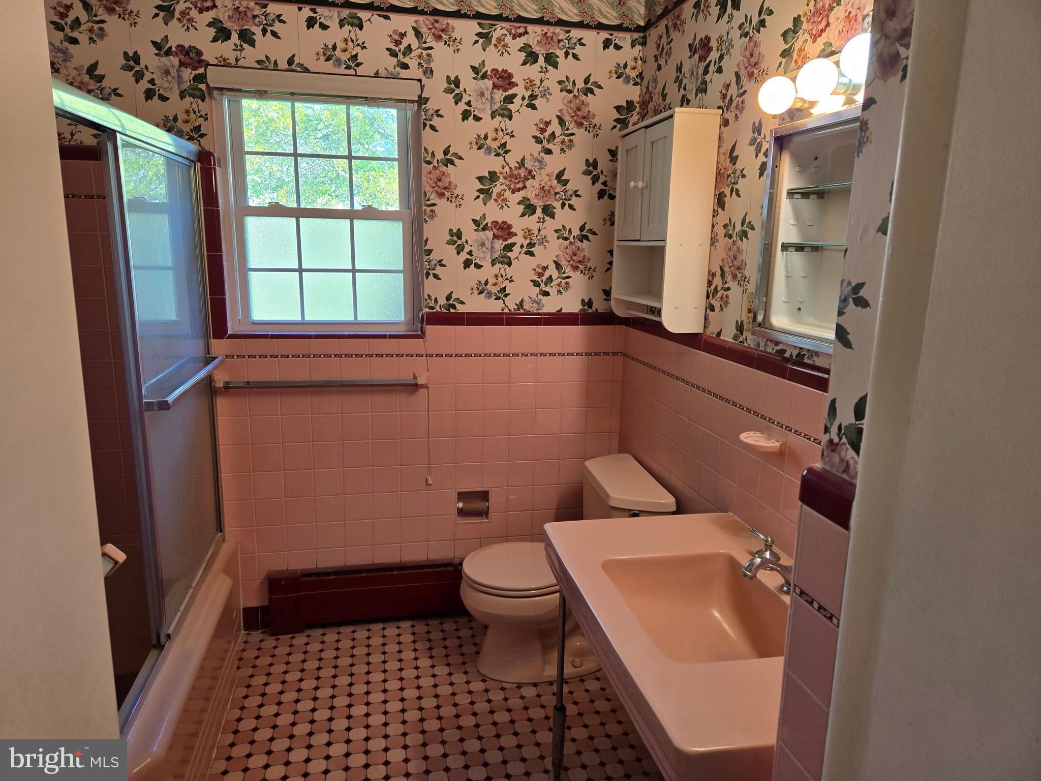 505 East Loockerman Street Dover, DE 19901 - Photo 24 of 38 a bathroom with a sink a toilet a window and shower