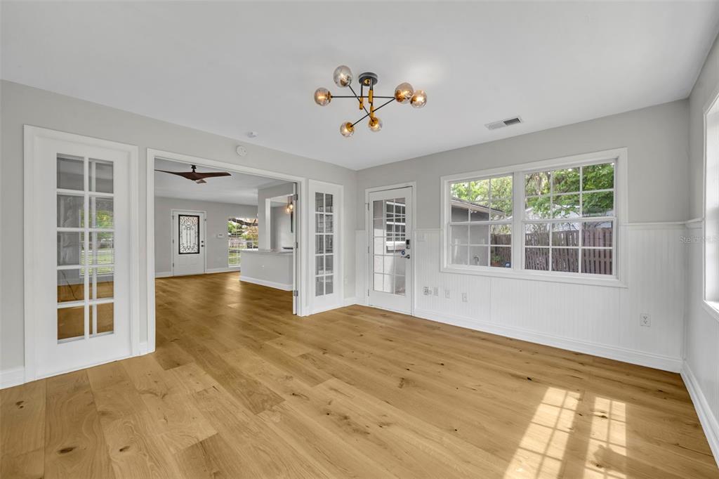 4234 Kendrick Road Orlando, FL 32804 - Photo 21 of 46 a view of an empty room with a window and wooden floor