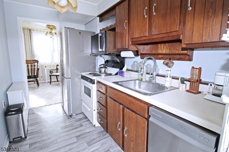 126 Baker Street Dover, NJ 07801 - Photo 5 of 11 a kitchen with stainless steel appliances granite countertop a sink stove and cabinets