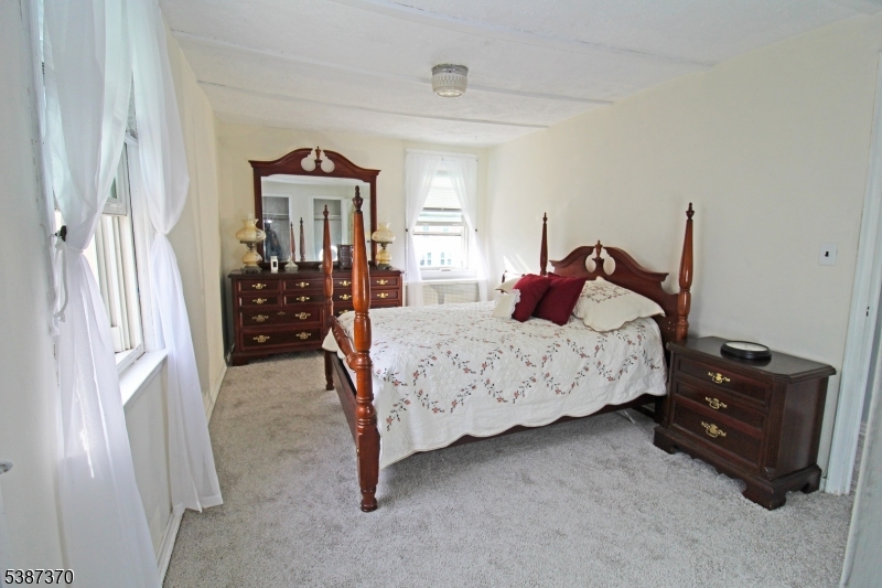 126 Baker Street Dover, NJ 07801 - Photo 6 of 11 a bedroom with a bed dresser and a window