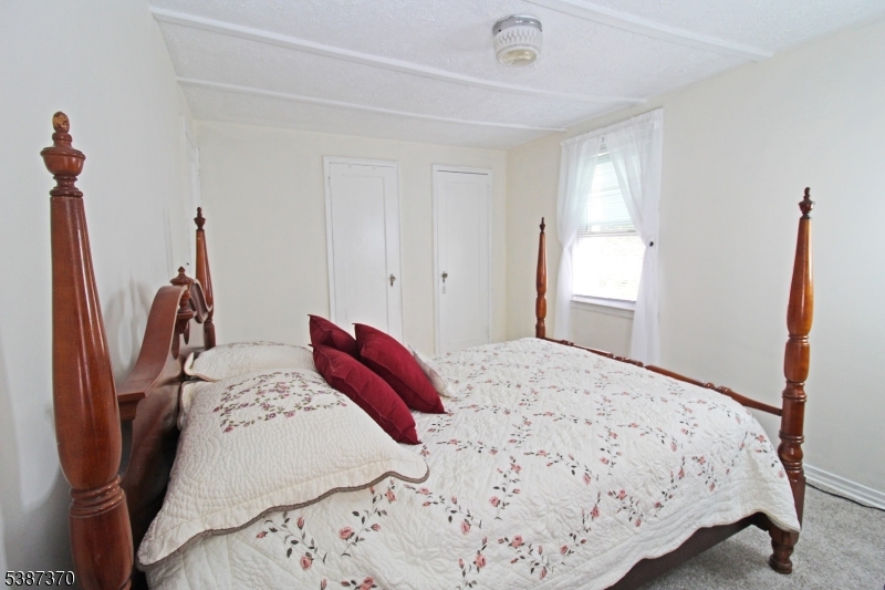 126 Baker Street Dover, NJ 07801 - Photo 7 of 11 a bedroom with a bed and a window