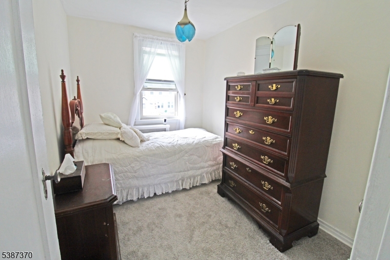 126 Baker Street Dover, NJ 07801 - Photo 8 of 11 a bedroom with a bed and a mirror