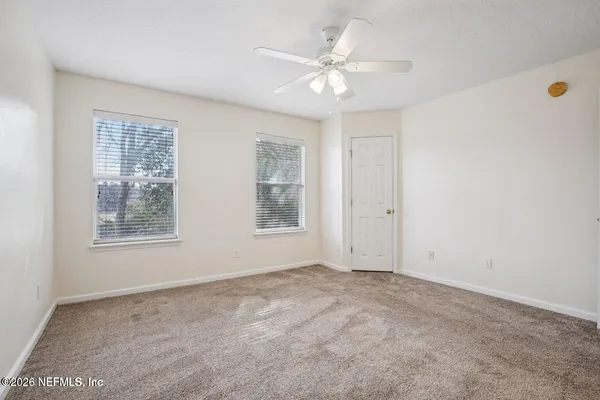 an empty room with windows and closet