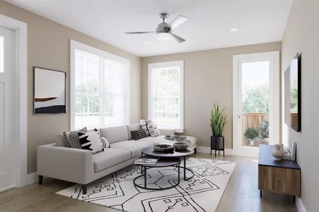 a living room with furniture and floor to ceiling windows