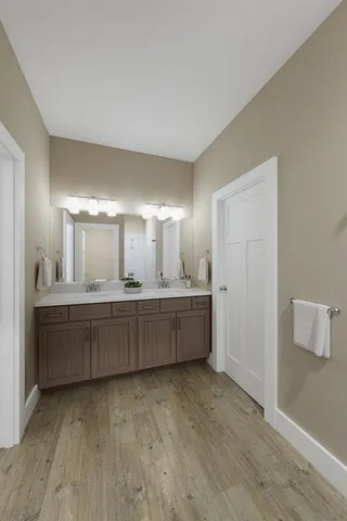 a large bathroom with a large mirror vanity and sink