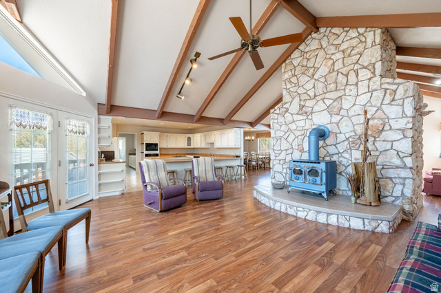6 South N Frk Road Orderville, UT 84758 - Photo 8 of 68 Living room featuring a wood stove, high vaulted ceiling, ceiling fan, light wood-style floors, and beamed ceiling