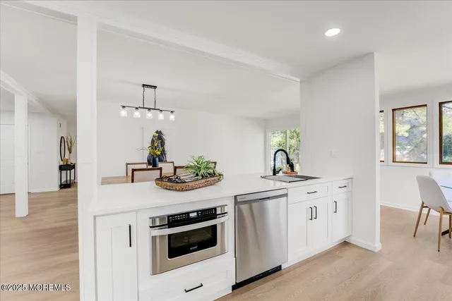 a kitchen with white cabinets and appliances
