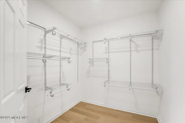 a spacious bathroom with a toilet sink double and mirror