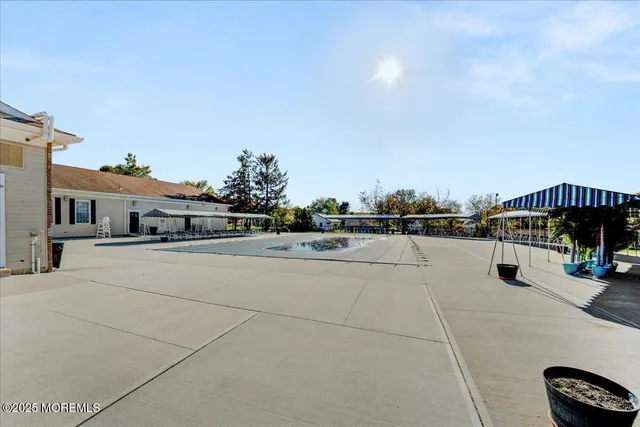 an aerial view of a house with swimming pool garden and outdoor seating