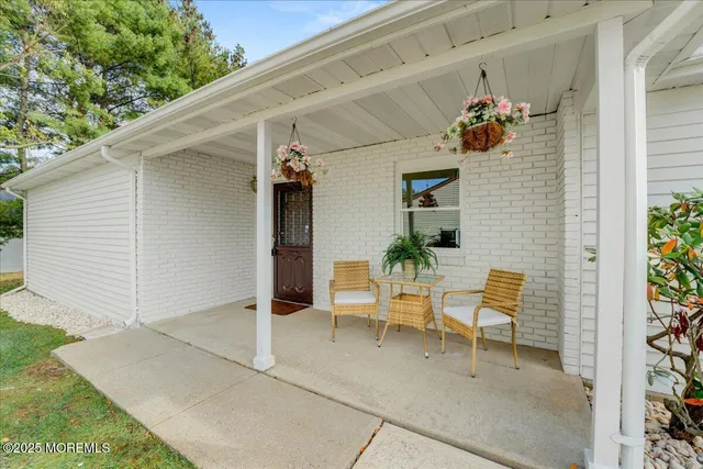 a view of two chairs in patio of the house