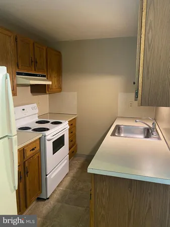 a kitchen with a stove cabinets and a sink