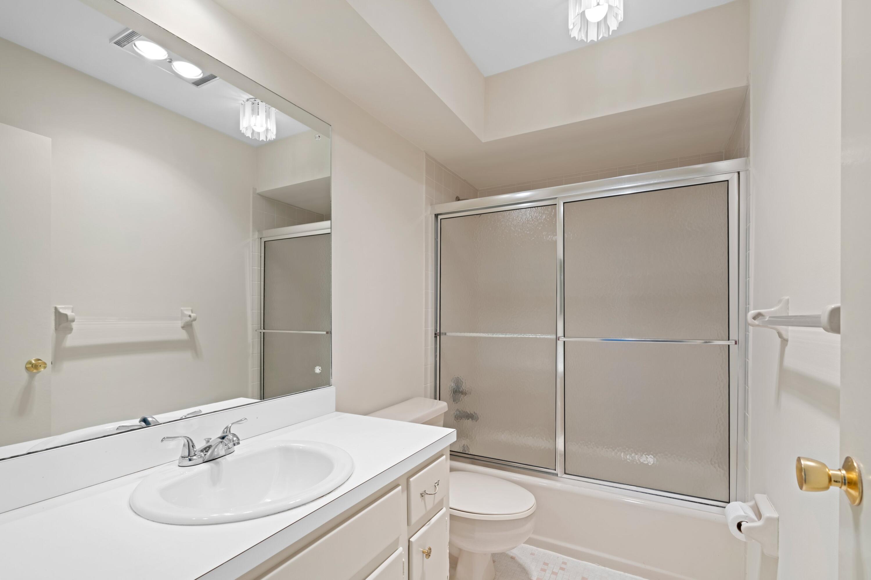 2301 Northeast 36th Street, Unit 204 Lighthouse Point, FL 33064 - Photo 13 of 20 a bathroom with a sink toilet and shower