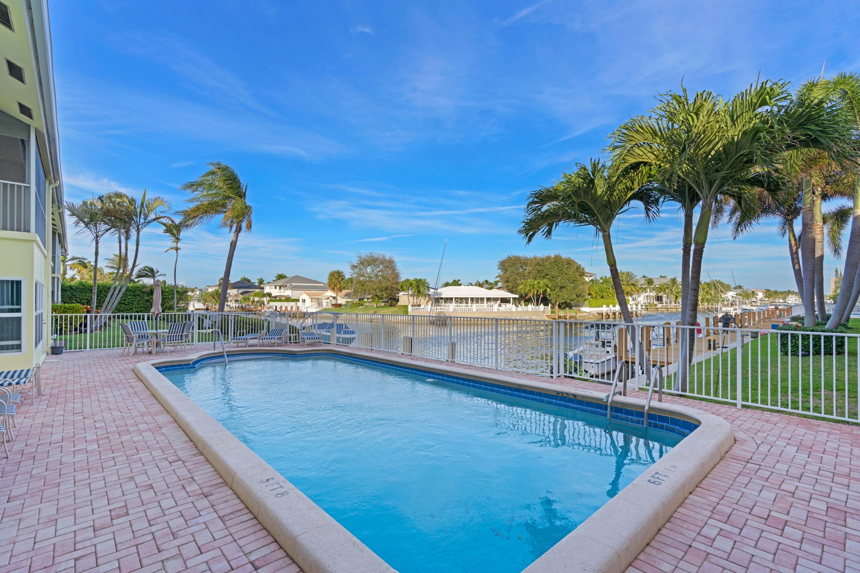 2301 Northeast 36th Street, Unit 204 Lighthouse Point, FL 33064 - Photo 15 of 20 a view of a swimming pool with a lounge chair