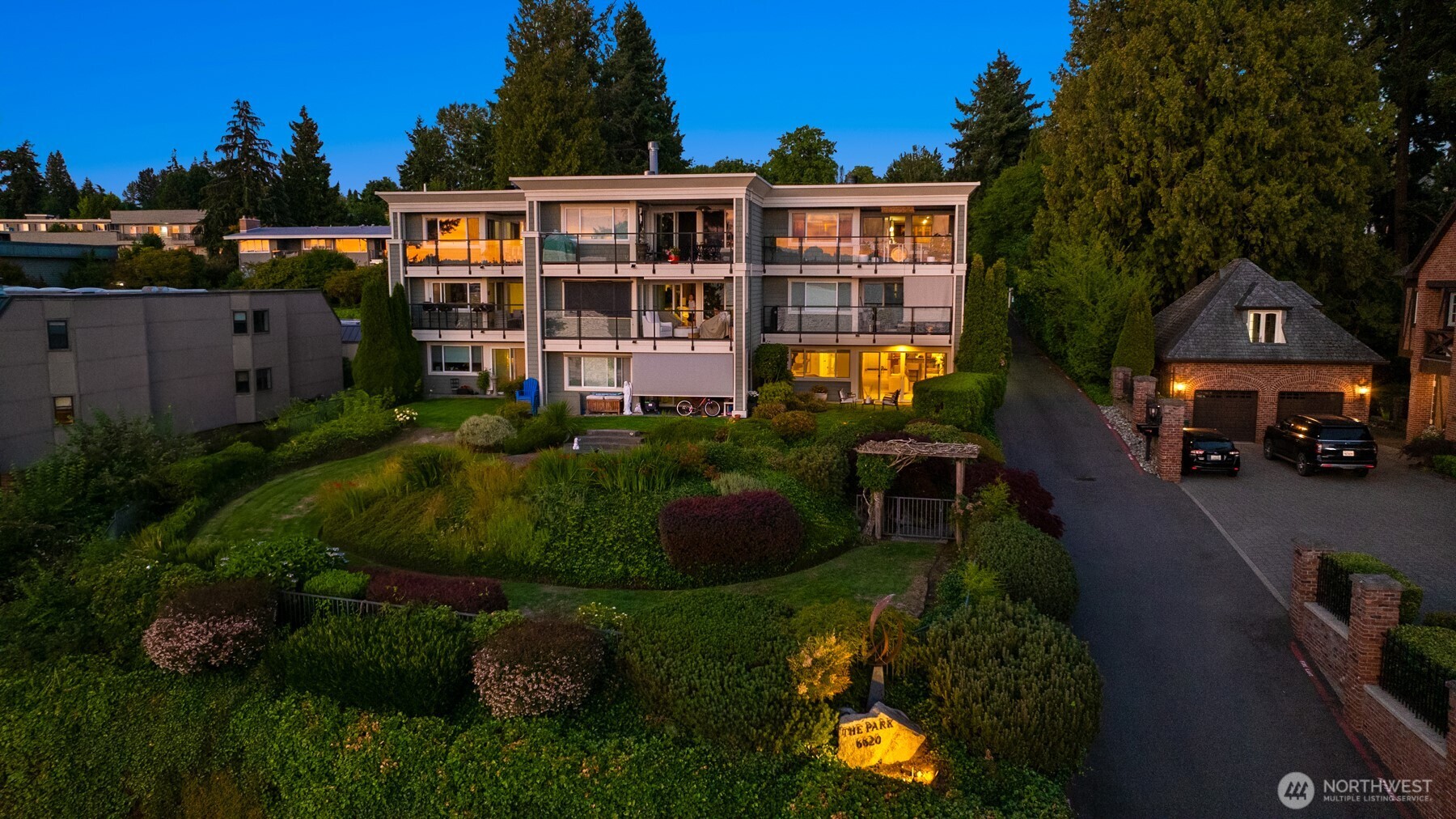 6620 Lake Washington Boulevard Northeast, Unit 101 Kirkland, WA 98033 - Photo 29 of 31 a front view of a house with a yard and outdoor seating