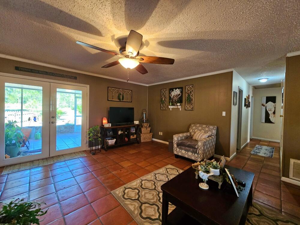 4017 Bear Creek Road Crestview, FL 32539 - Photo 13 of 28 a living room with furniture and a fireplace