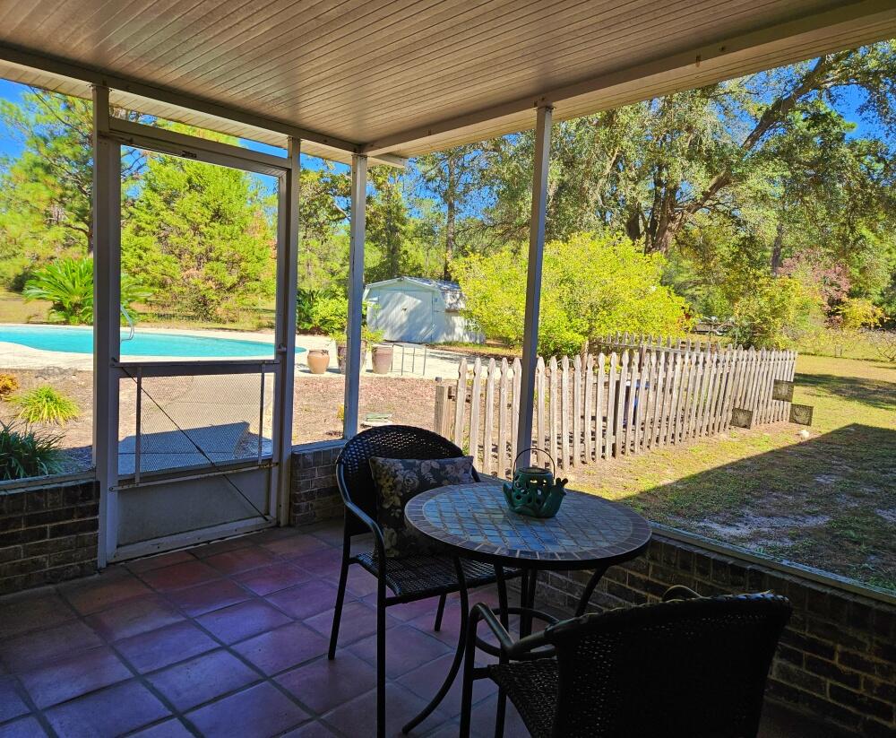 4017 Bear Creek Road Crestview, FL 32539 - Photo 21 of 28 a view of a dining room with furniture window and outside view