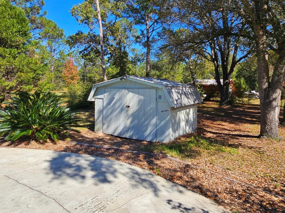 4017 Bear Creek Road Crestview, FL 32539 - Photo 24 of 28 a view of a yard with large tree