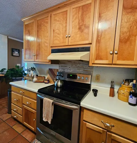 a kitchen with stainless steel appliances granite countertop a stove and a microwave