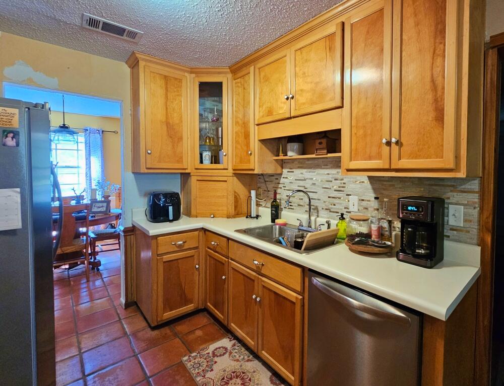 4017 Bear Creek Road Crestview, FL 32539 - Photo 5 of 28 a kitchen with stainless steel appliances granite countertop a sink stove and cabinets
