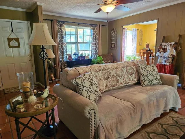 a living room with a couch and a chandelier