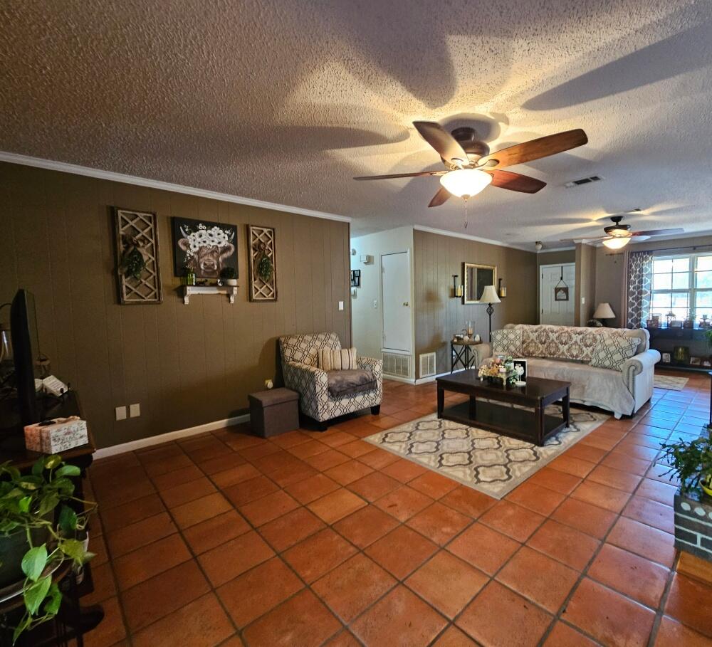 4017 Bear Creek Road Crestview, FL 32539 - Photo 10 of 28 a living room with furniture and a chandelier