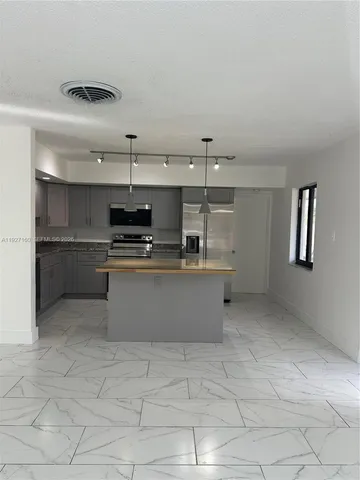 a bathroom with a granite countertop sink a toilet and mirror
