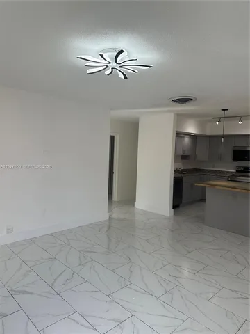 a bathroom with a granite countertop sink a mirror and a shower
