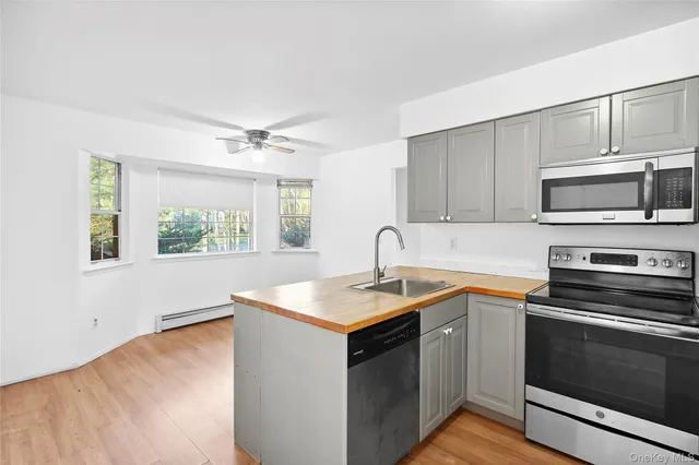 a kitchen with stainless steel appliances granite countertop a sink stove and microwave