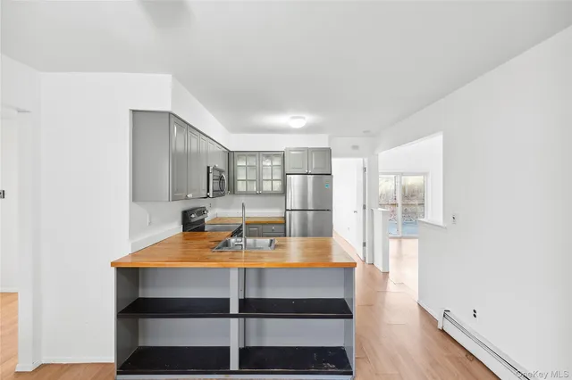 a room with furniture and view of kitchen