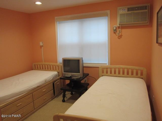 203 Westcolang Road Lackawaxen, PA 18435 - Photo 14 of 15 a bed room with a bed and a chair