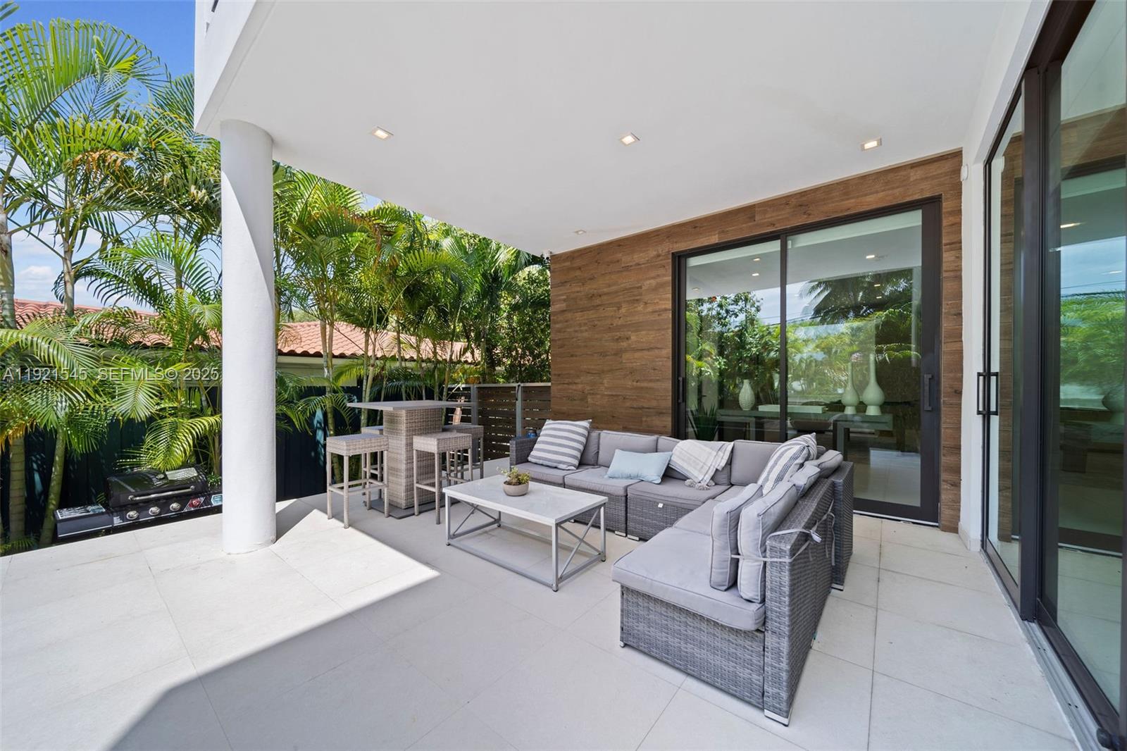 4740 Alton Road Miami Beach, FL 33140 - Photo 11 of 34 a outdoor space with patio couch and outdoor seating