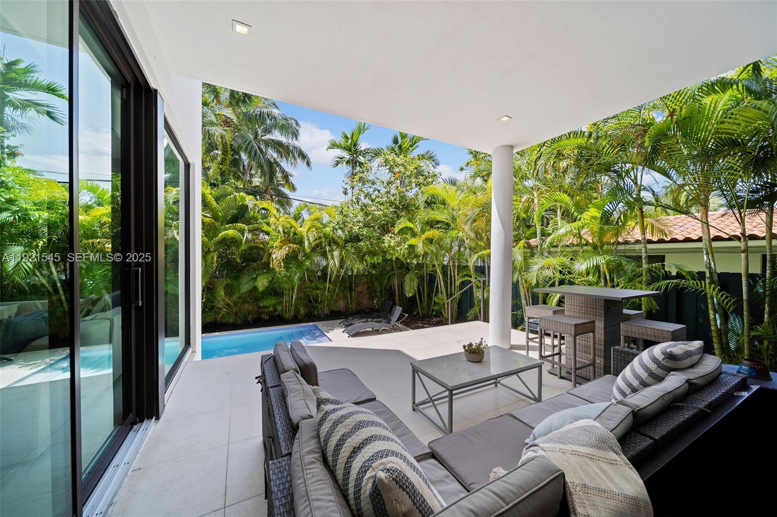 4740 Alton Road Miami Beach, FL 33140 - Photo 12 of 34 a outdoor living space with furniture