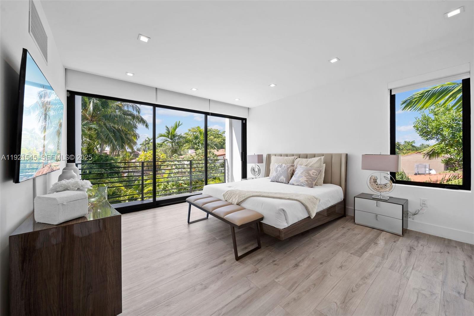 4740 Alton Road Miami Beach, FL 33140 - Photo 14 of 34 a spacious bedroom with a large bed and a large window