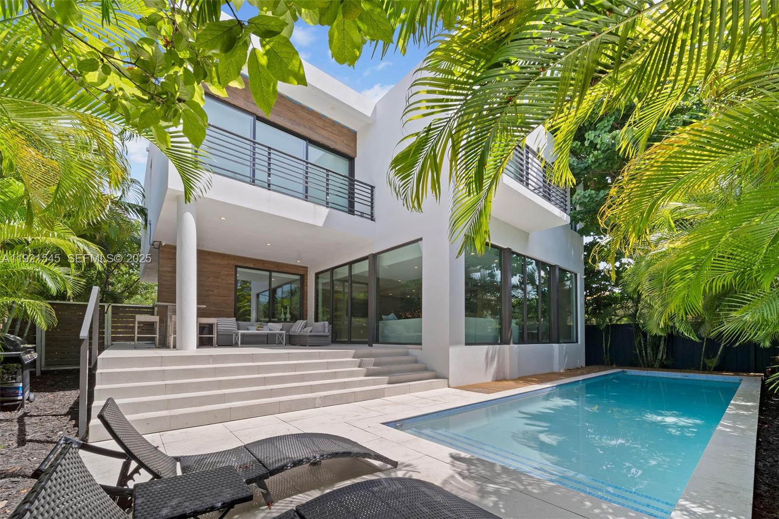 4740 Alton Road Miami Beach, FL 33140 - Photo 2 of 34 a view of a house with backyard and sitting area