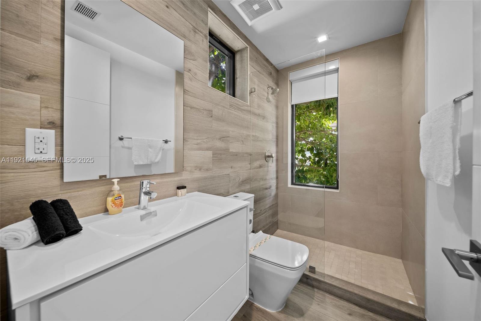 4740 Alton Road Miami Beach, FL 33140 - Photo 23 of 34 a bathroom with a sink toilet and shower