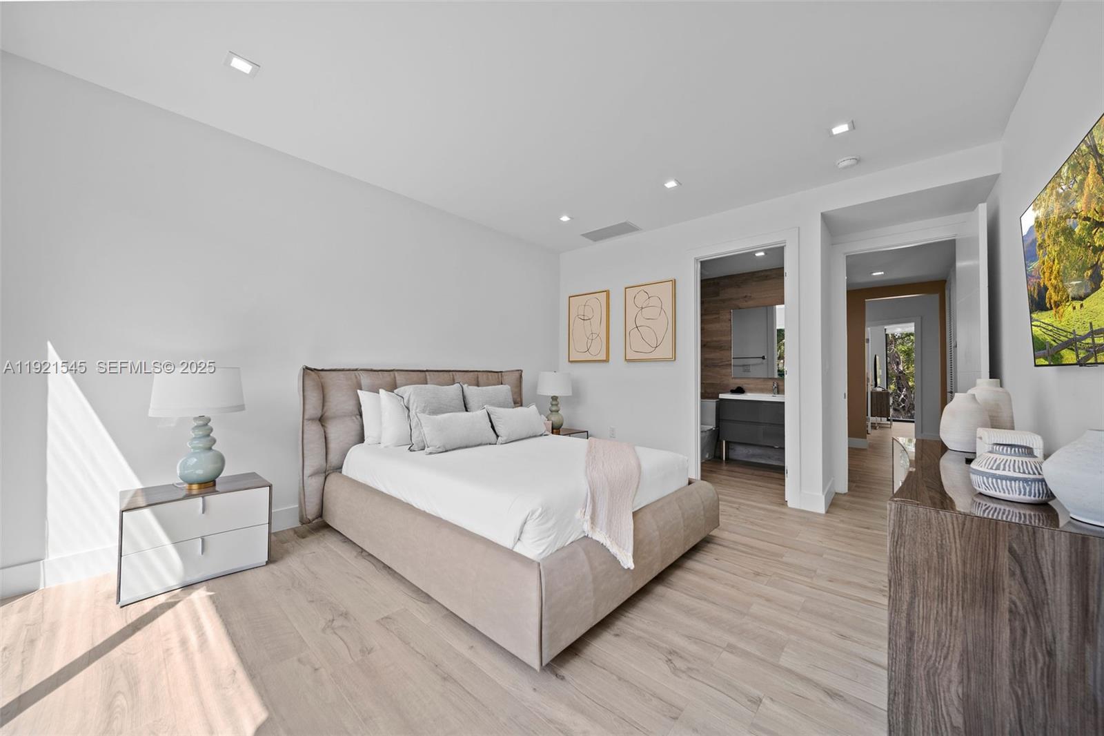 4740 Alton Road Miami Beach, FL 33140 - Photo 26 of 34 a spacious bedroom with a bed and a couch