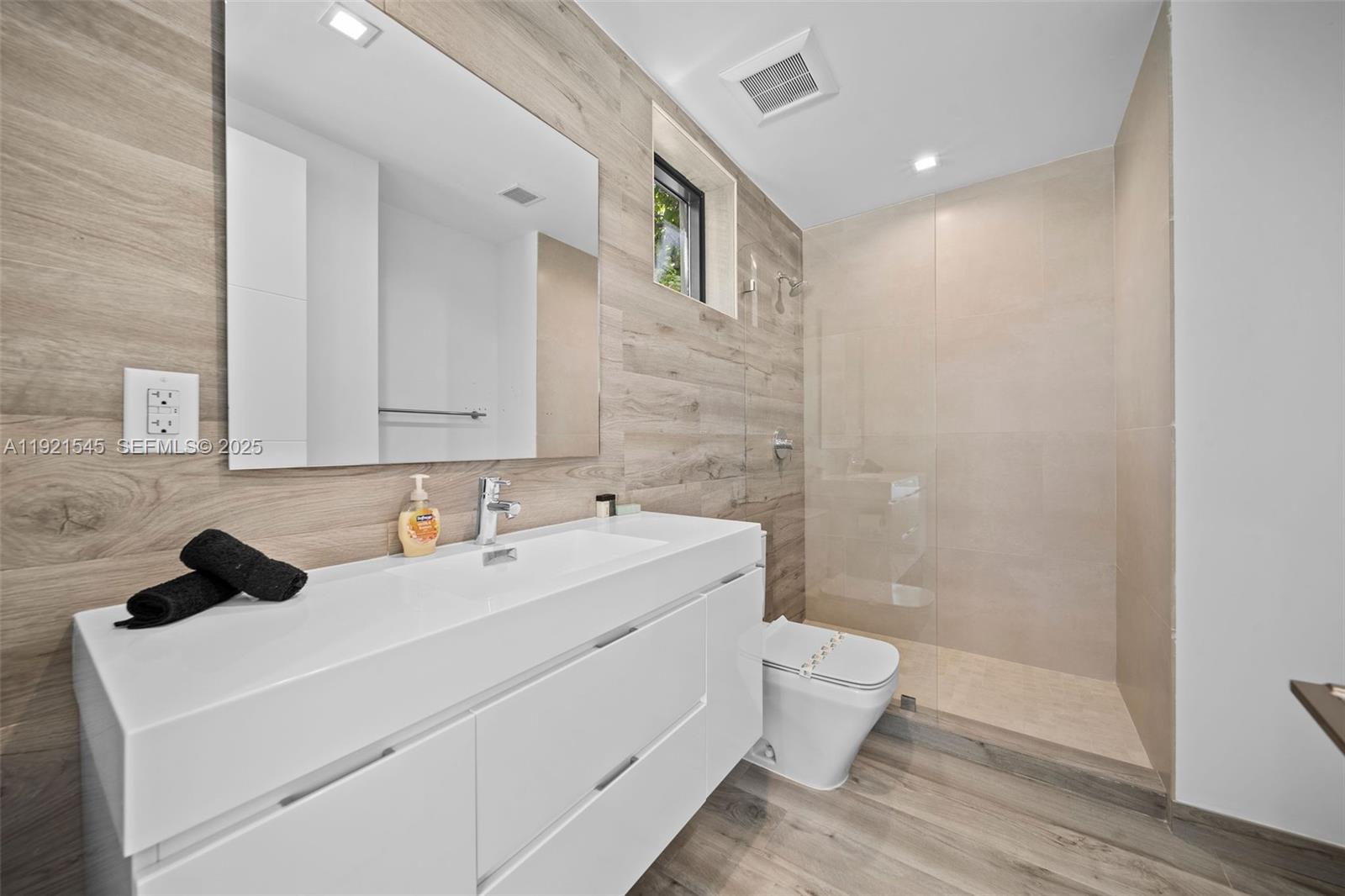 4740 Alton Road Miami Beach, FL 33140 - Photo 27 of 34 a bathroom with a sink a toilet and shower