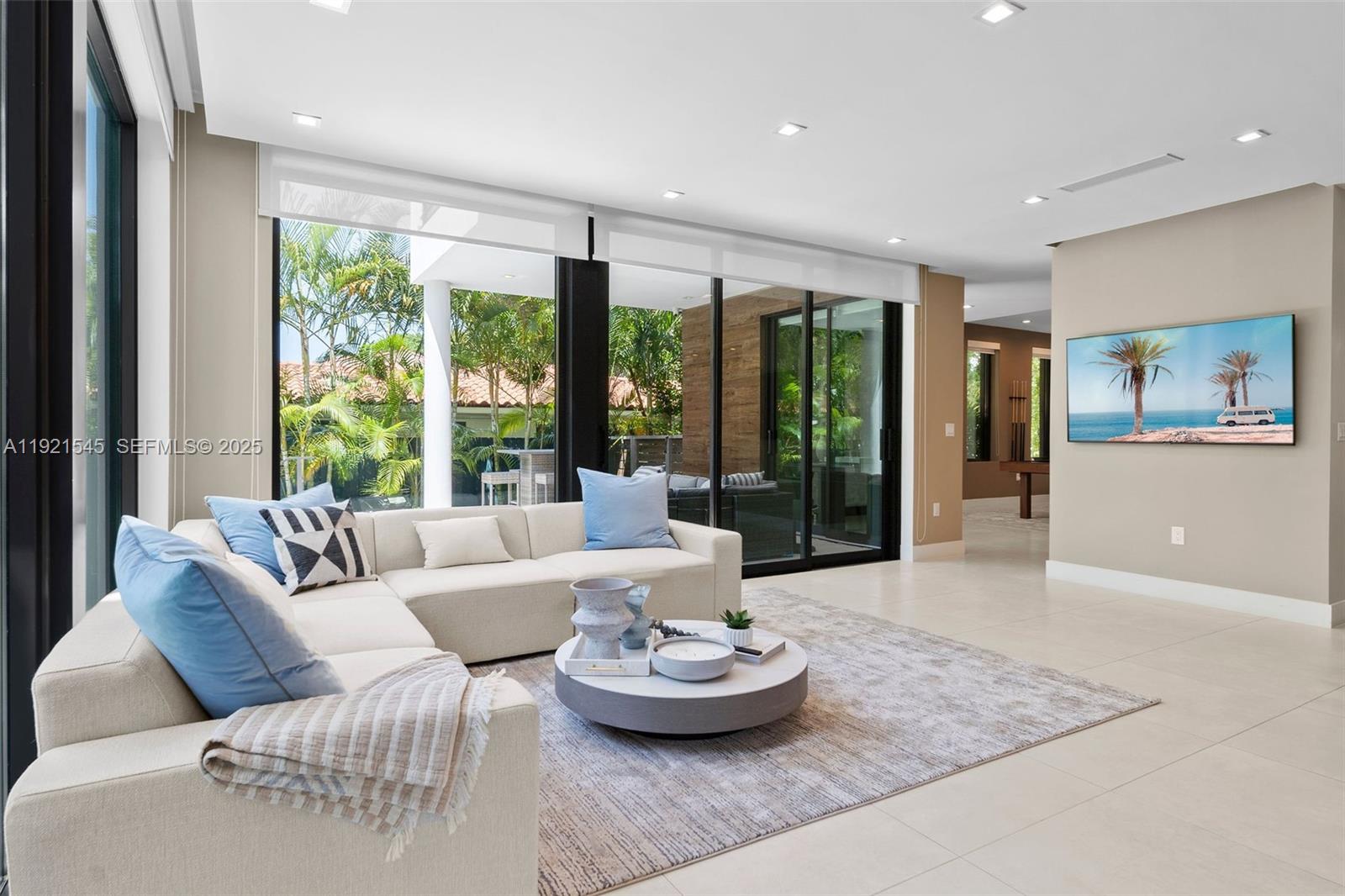 4740 Alton Road Miami Beach, FL 33140 - Photo 3 of 34 a living room with furniture and a large window
