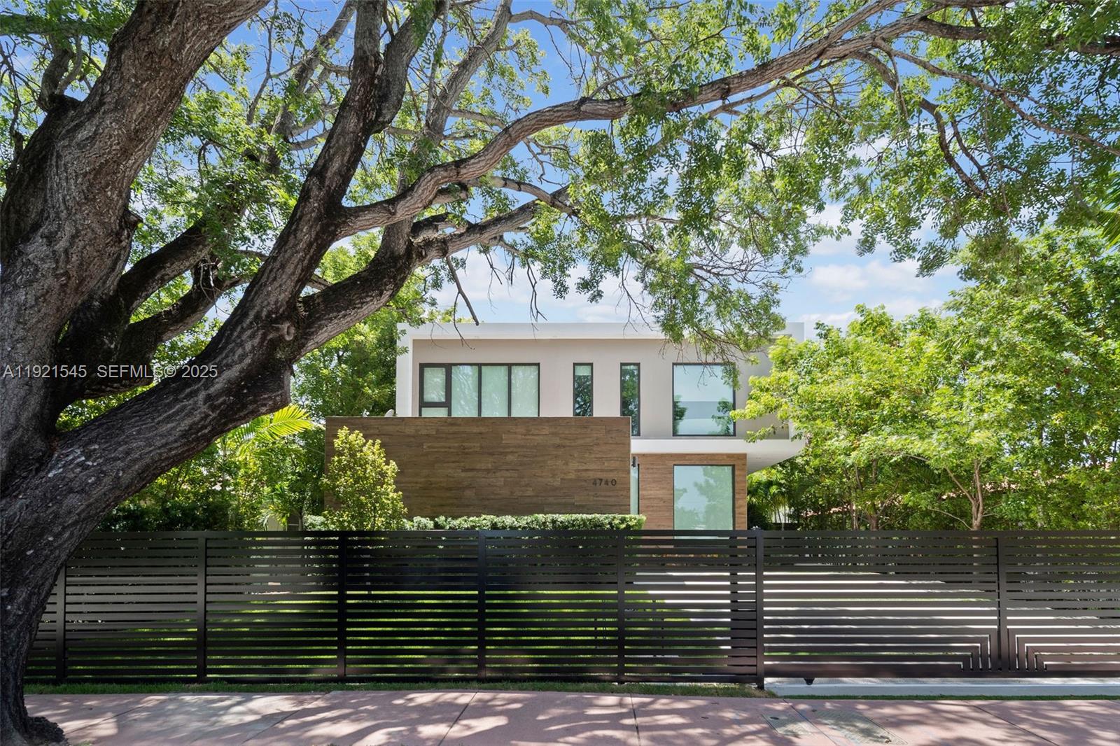 4740 Alton Road Miami Beach, FL 33140 - Photo 33 of 34 a front view of a house with a garden